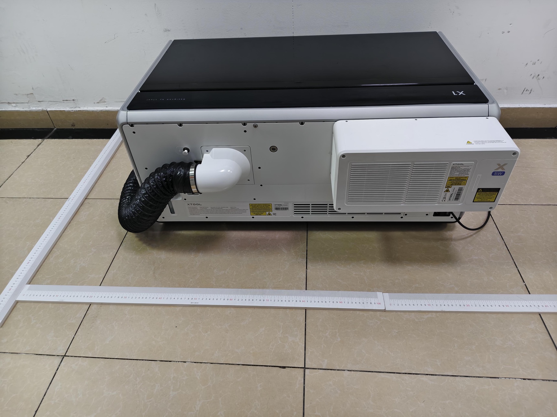 FCC exhibit photograph of xTool X1 rear with rulers around the machine, exhaust duct and 5 watt module
