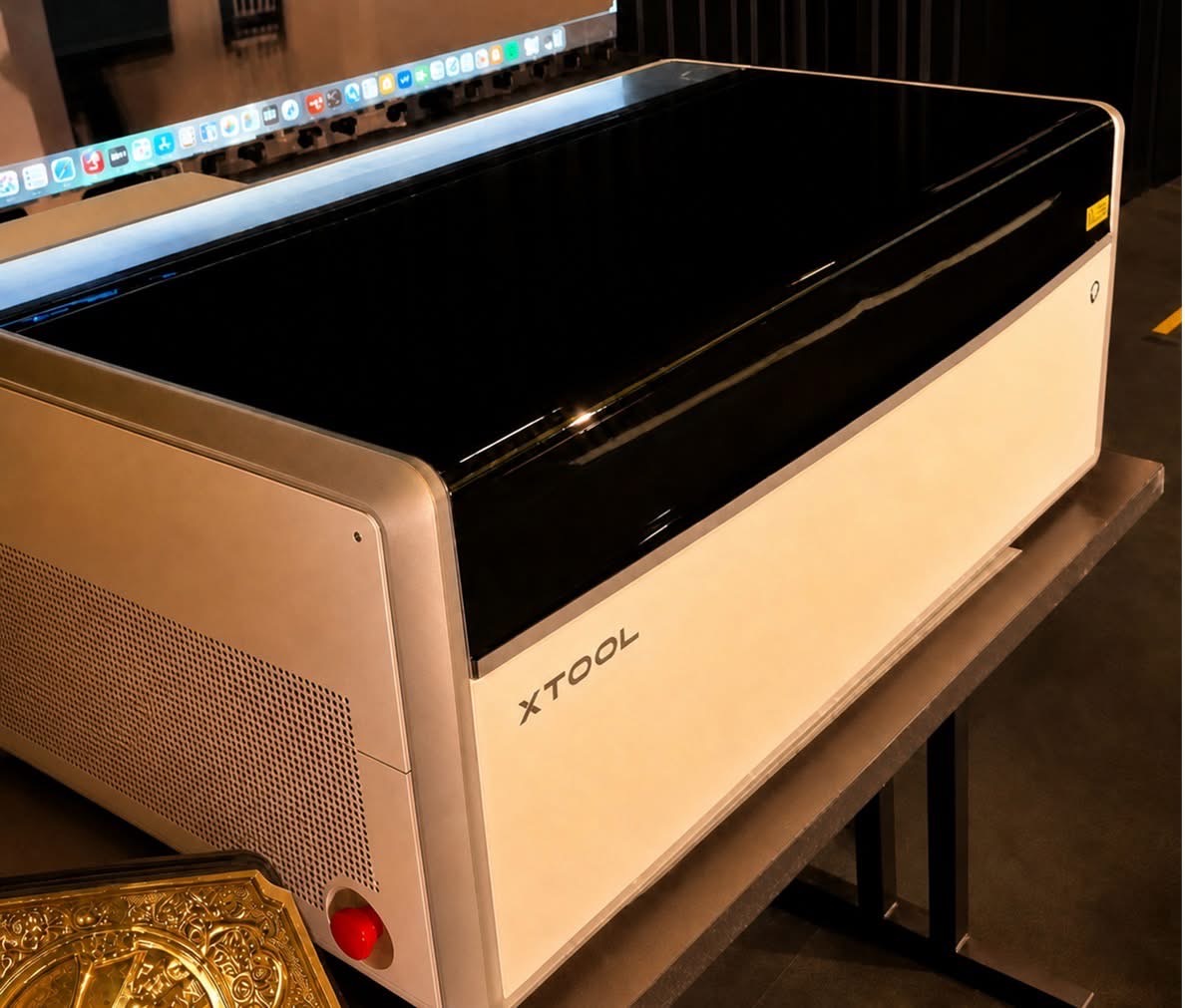 xTool X1 prototype at the launch event, showing its white enclosure, dark lid and large internal gantry