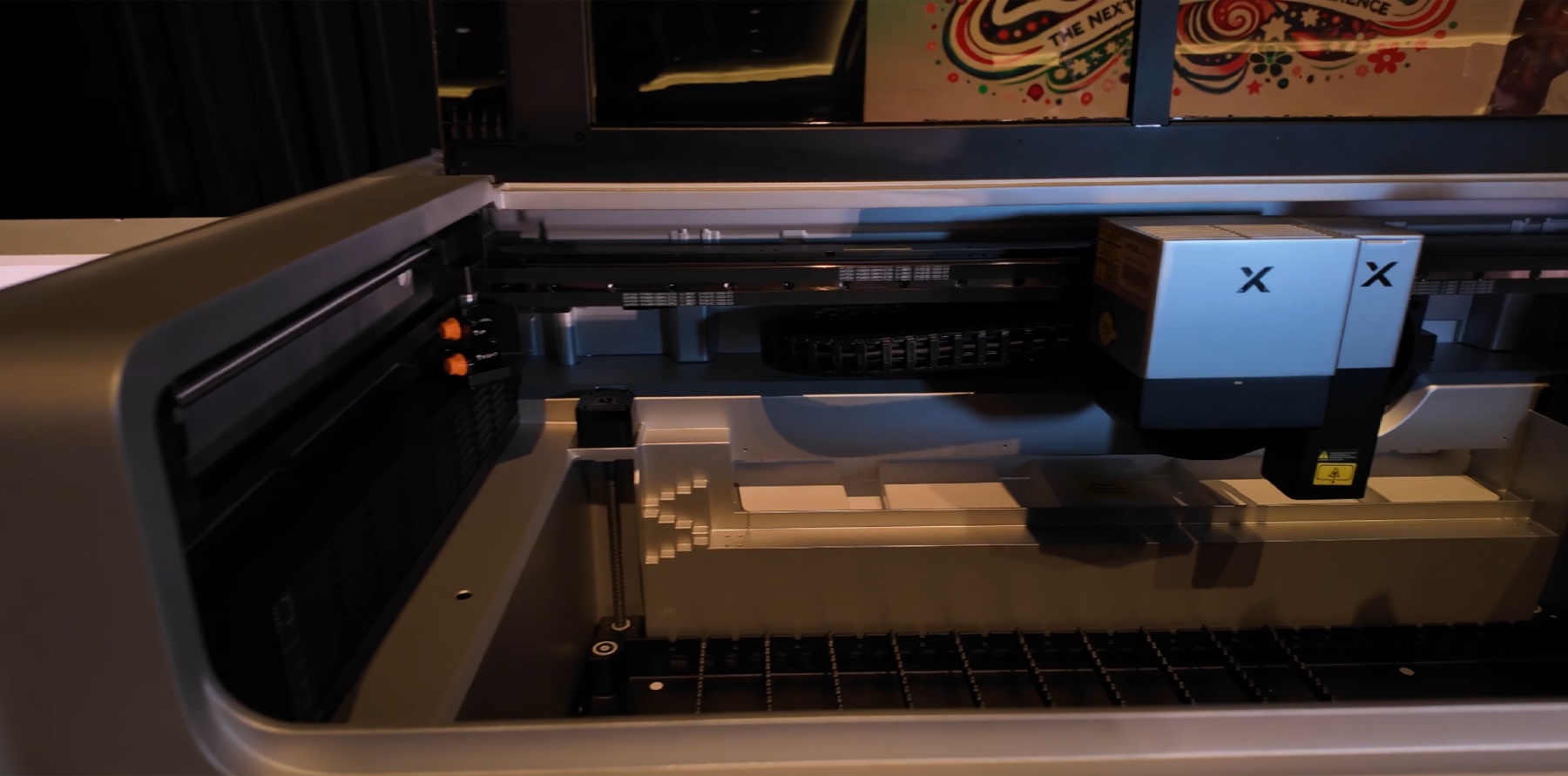 Wide interior view of the xTool X1 showing the dual head, gantry, base platform and left-side Z lead screw