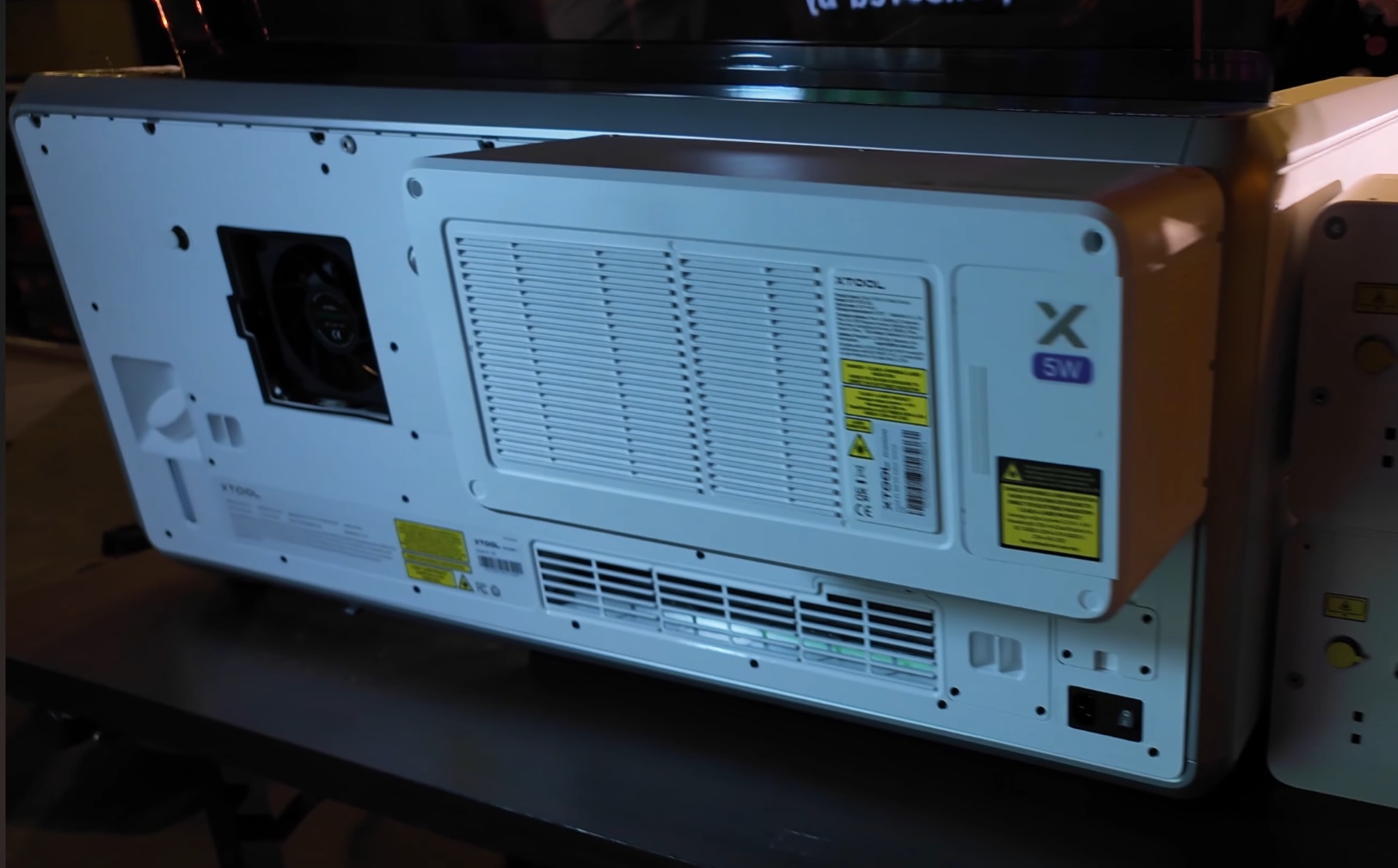 Rear of xTool X1 showing a large ventilated white module labeled 5W