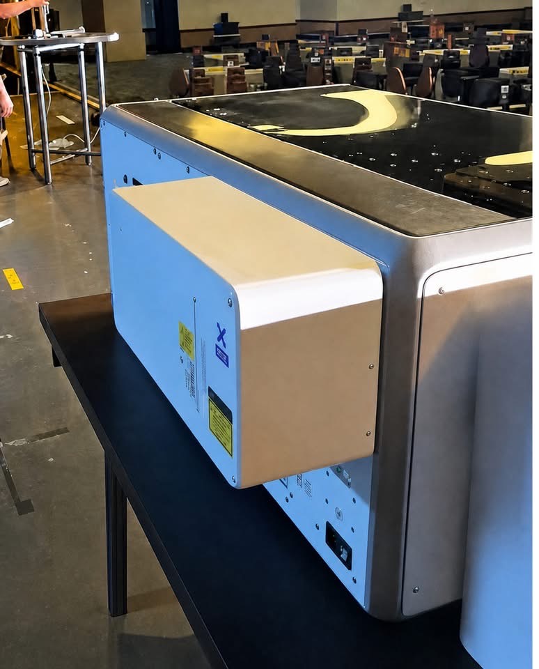 Rear-mounted xTool X1 module with a 5 W badge and UV laser warning label